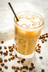 coffee ice cubes and beans with latte on stone desk background