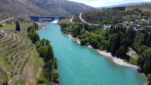Clyde River and Clyde Dam, New Zealands third largest Hydroelectric Dam. Aerial pan up reveal.