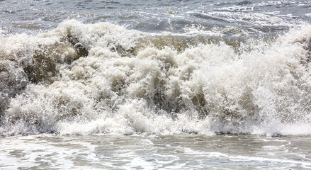 Splashing big waves on the seashore.