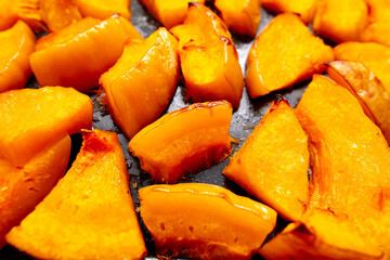Pieces of pumpkin baked on a baking sheet. Food