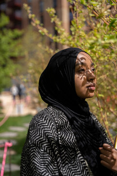 Portrait of a Black Muslim woman with shadows on her face
