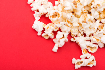 Heap of delicious popcorn isolated on background. Scattered popcorn texture background. Selective...