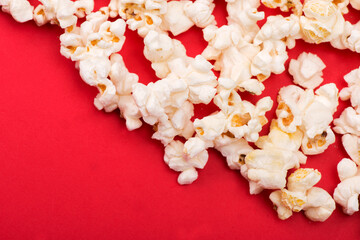 Heap of delicious popcorn isolated on background. Scattered popcorn texture background. Selective focus.