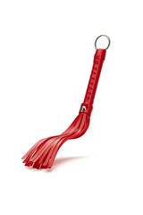 Detail shot of red whip with fringe and steel ring on twisted handle. Leather tool for erotic games...