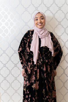 Portrait of a Black Muslim woman wearing a pink hijab