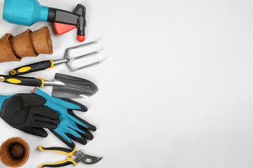 Flat lay composition with gardening tools on white background, space for text