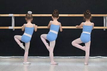 little girls are engaged in the class of a choreographic school