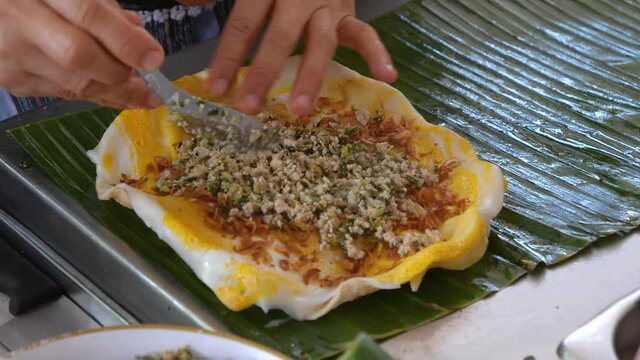 Vietnamese crispy rice paper cracker layered with egg, minced pork, vietnamese sausage and vegetable.