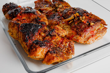 American food concept. Grilled pork ribs with grilled sauce, with smoke, spices and rosemary. Closeup of pork ribs grilled with BBQ sauce and caramelized in honey. 