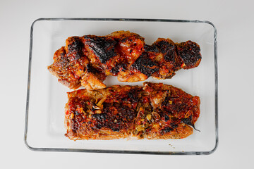 American food concept. Grilled pork ribs with grilled sauce, with smoke, spices and rosemary. Closeup of pork ribs grilled with BBQ sauce and caramelized in honey. 