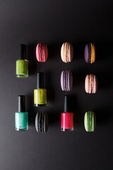 Different colored macarons and nail polishes