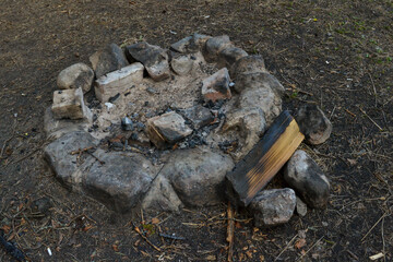 fireplace has been created with stones in a tourist recreation area in the forest.