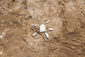 the sun laid out on the sand of stones