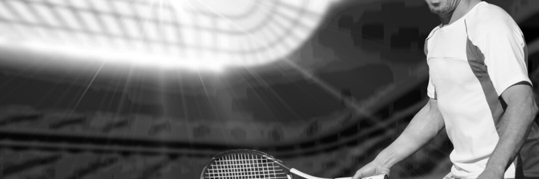 Composition of midsection of man playing tennis over sports stadium in black and white