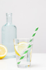 Lemonwater with colorful paper straw. Healthy detox drink. 