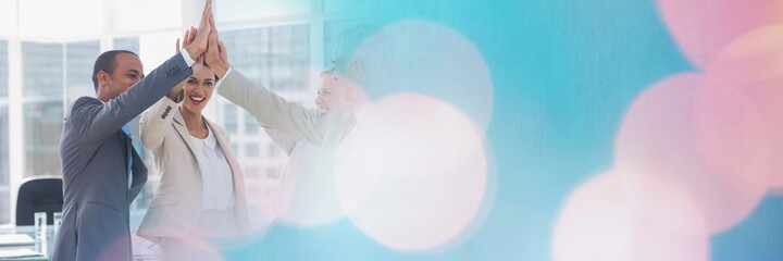 Composition of business people high fiving with spots of light