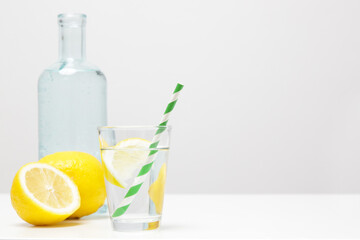 Lemonwater with colorful paper straw. Healthy detox drink. 