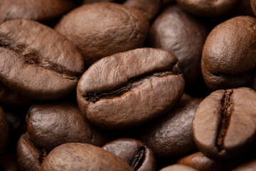 Brown roasted coffee beans close up full frame as a background 