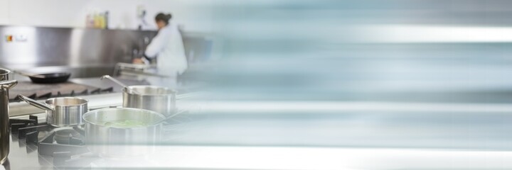 Composition of female chf in professional kitchen with motion blur
