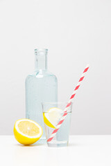 Lemonwater with colorful paper straw. Healthy detox drink. 