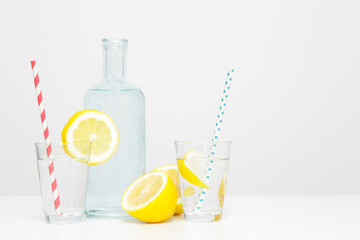 Lemonwater with colorful paper straw. Healthy detox drink. 