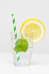 Lemonwater with colorful paper straw. Healthy detox drink. 