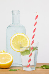 Lemonwater with colorful paper straw. Healthy detox drink. 