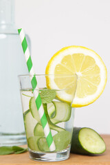 Lemon cucumber water with colorful paper straw. Healthy detox drink. 