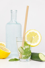Lemon cucumber water with bamboo straw. Healthy detox drink. Reusable bamboo straws as an alternative for single-use plastic straws, healthy and sustainable lifestyle concept