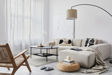 Domestic interior of living room with design modular sofa, black coffee table, lamp, armchair,...