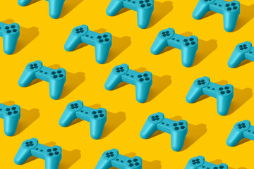 Pattern with bright blue retro game joypad controllers on yellow background. Minimal Flat lay concept. 3d render. © Santijago