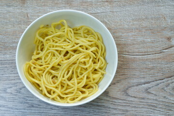 fried Yakisoba yellow Japanese noodles with oil on white bowl