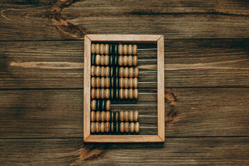 wooden small trading abacus on a background of boards.