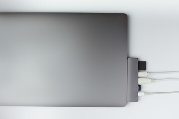 Close-up photo of type-c hub with cables and card connected to laptop