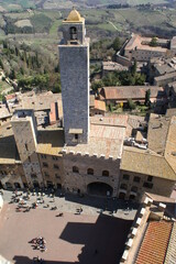 Fototapeta na wymiar Aerial view of San Gimignano in Tuscany (Italy): piazza Duomo and Palazzo Vecchio del Podestà with Torre Grossa