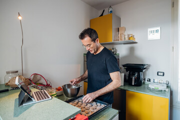 Adult man indoor at home kitchen preparing food