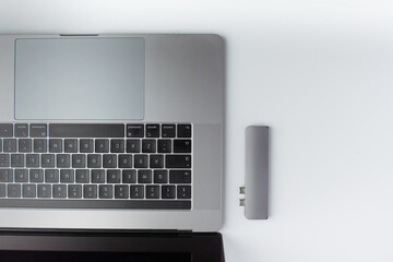 Close-up photo of a USB type-c hub that lies to the side of the laptop
