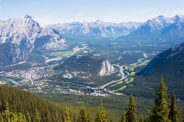 Beautiful aerial view of Rocky Mountains and river. Banff city in the valley. Alberta, Canada