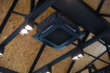 New black air conditioning vent on ceiling modern restaurant, inside background. Modern Heavy...