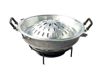 Empty metallic BBQ pan set on charcoal stove. Thai buffet food with pork and meats, cooked on the...