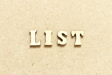 Alphabet letter in word list on wood background