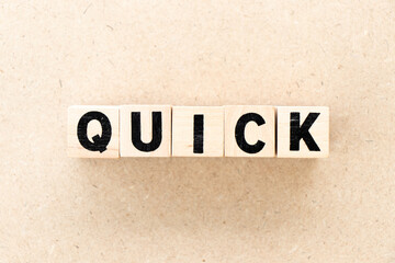Alphabet letter block in word quick on wood background