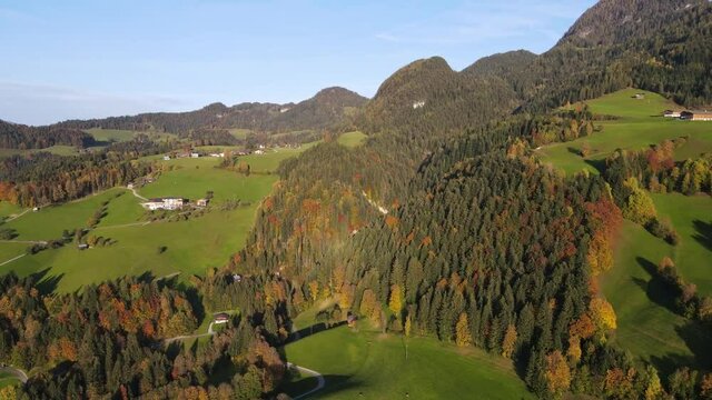 A Drone shot of mountains and valleys with scattered houses in the Austrian Alps near Brixlegg and Alpbach