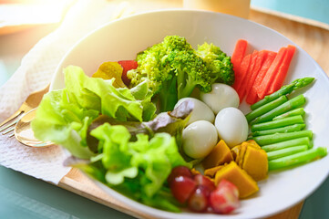 salad with vegetables and greens on wooden table