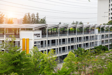 Solar panels system lined up in a parking building to store solar electricity in Thailand. Many Solar cells in a row on top of roof, Natural day light, outside top view