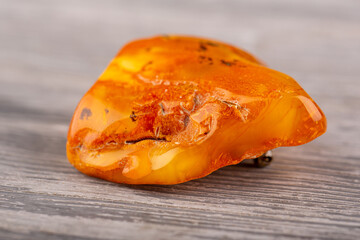 Brooch on a silver lock from a natural raw piece of amber
