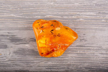 Brooch on a silver lock from a natural raw piece of amber