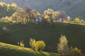 Rural mountain landscape with remote Romanian village uphill in the valleys of Carpathian...