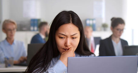 Fototapeta na wymiar Worried stressed businesswoman looking at laptop screen sitting in office