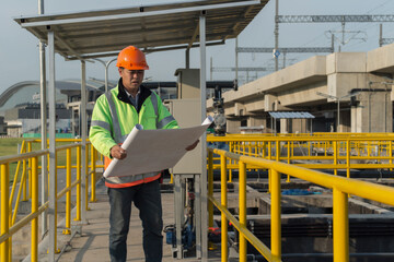 engineer at work. worker checking drawing  on site construction.